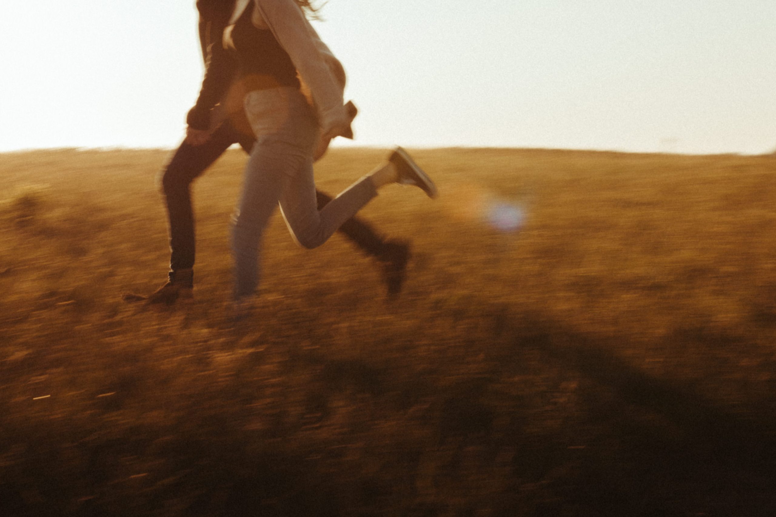 couples running at sunset at lawrencetown beach