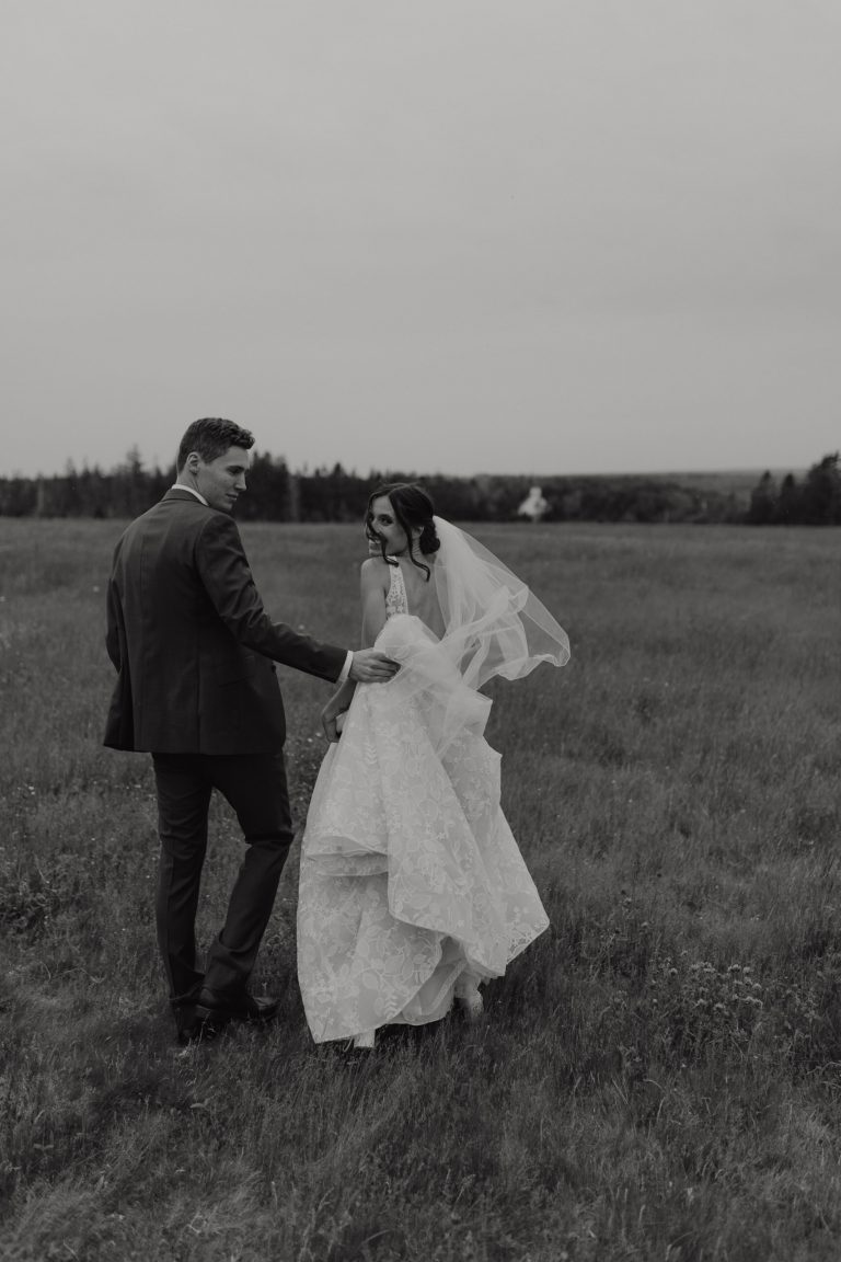 couples on wedding day walking in the field